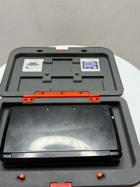 Nintendo Black Handheld Console with Gray Case and Orange Accents